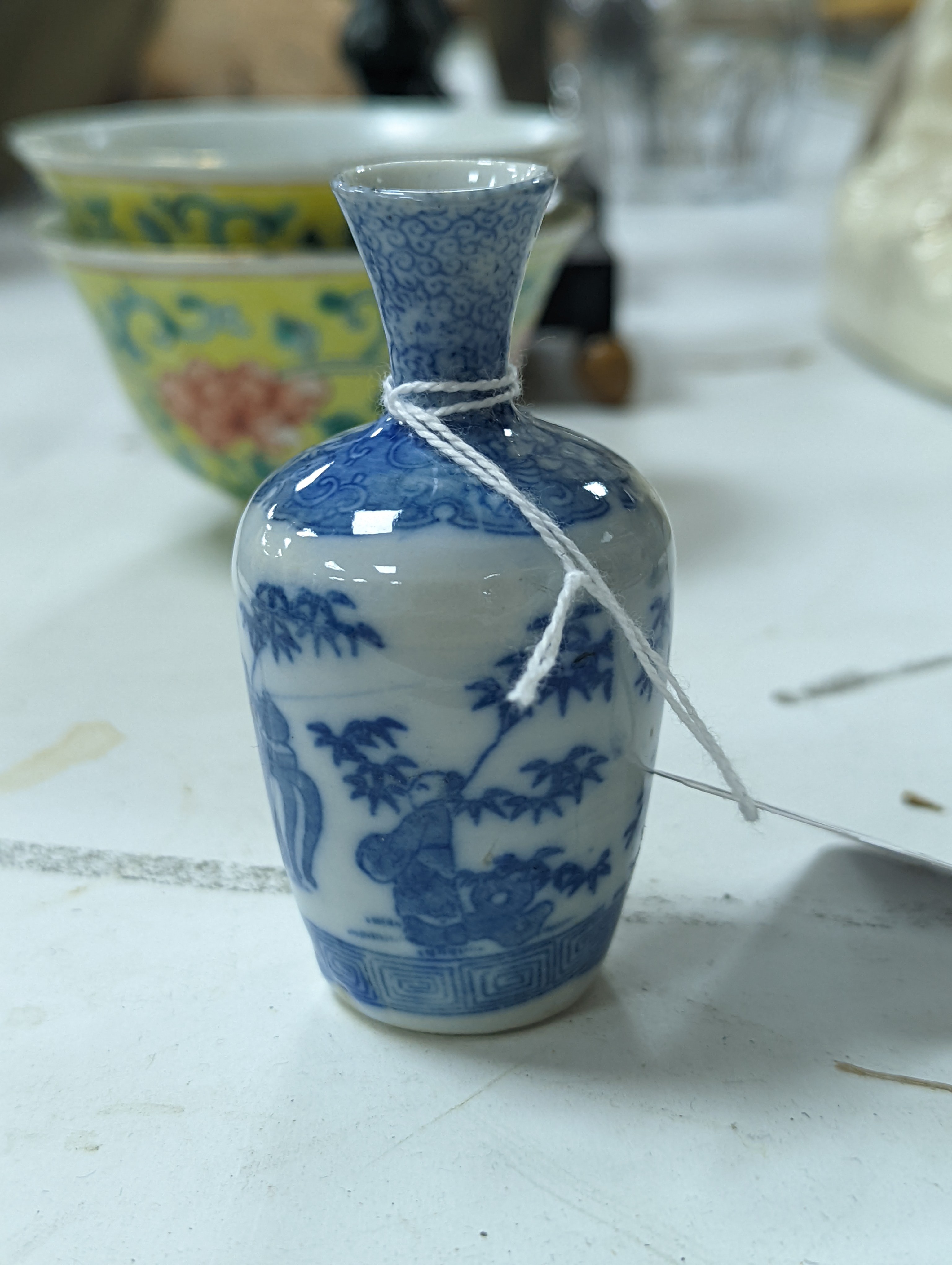 A group of Chinese porcelain, 19th /20th century, to include a pair of yellow ground bowls, 10.8 cm diameter, a blue and white vase, Xuande mark, a similar bowl and vase, and a champleve enamel bronze koro and cover